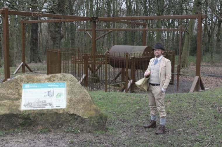 A mining wheel in Middleton Park with a Middleton Railway member dressed as a local miner of the day.